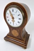 An Edwardian balloon shape clock, with inlaid decoration, Roman enamel dial with intricate gilt