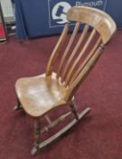 A beech farmhouse rocking chair, turned spindle back design.