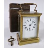 A brass carriage clock, cased, Roman enamel dial.