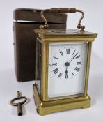 A brass carriage clock, cased, Roman enamel dial.