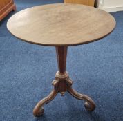 A small round tea table or wine table, on elaborate scroll feet, height 58cm.