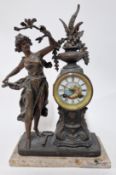 An early 20th century mantle clock, grey marble base, with a bronzed spelter classical woman among
