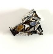 A silver contemporary style brooch/pendant set with precious stones and gold, approx 26.8g, makers