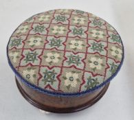 A small wooden footstool box with woven seat.