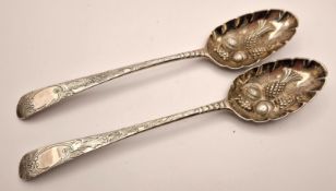 A pair of George III silver fruit spoons, decorated with embossed pineapples and melons to the