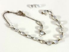A moonstone set necklace, set in gold metal, loose stones.