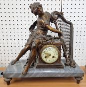 An early 20th century mantle clock, grey marble base with bronzed spelter muse playing a harp over a