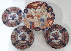 Three Japanese Imari plates, Meiji period (1868-1912), each of lobed decorated in the centre with