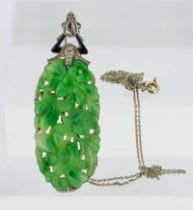 A good c1920's carved Jade pendant set with diamonds and enamel, approx length of jade 4cm.