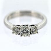 A diamond three stone ring, set in 18ct white (hallmark rubbed), size K/L.