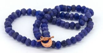 A Necklace strung with faceted reconstituted blue onyx beads, with a rose and bar clasp, Onyx 350.