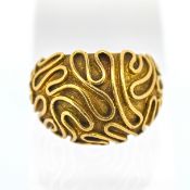 A 'swirl' domed design ring, set in gold (hallmark on outside band but rubbed), size P, approx 11.
