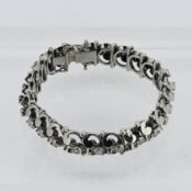 A stunning diamond bracelet, of stirrup swirl design, set in white gold, approx 2.50ct, length 17cm,