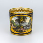 An early 19th century Derby cup, marked to base 'In Cumberland', of blue and gilt decoration,