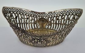 A pierced silver basket dish, of foliate design with embossed fruit basket, hallmarked indistinct,