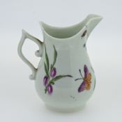 A Worcester milk jug, with floral and butterfly decoration by James Rogers.