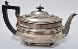 A George III silver teapot, hallmarked London 1810, on bun feet with ebonised handle and finial,