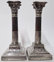 A pair of Edward VII silver candlesticks, in the form of corinthian columns, hallmarked Sheffield