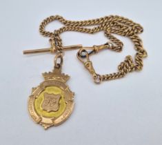 A 9ct gold albert watch chain with a 9ct gold football medal, total weight approx 36.2g.