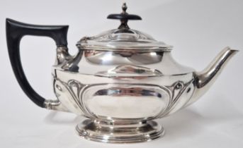 A silver teapot, hallmarked Sheffield 1912, with ebonised wooden handle and finial, total weight