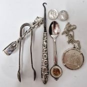 A pair of continental silver sugar tongs in the form of leaves, marked 800, together with a silver
