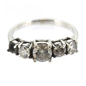A five stone diamond set ring, set in 18ct white gold, size Q/R (one diamond is
