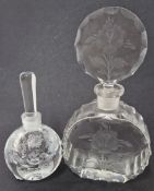 Two glass perfume bottles with stoppers, with floral decoration, one inscribed to base. (2)
