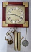 A Seiko wall clock, with weights and pendulum.