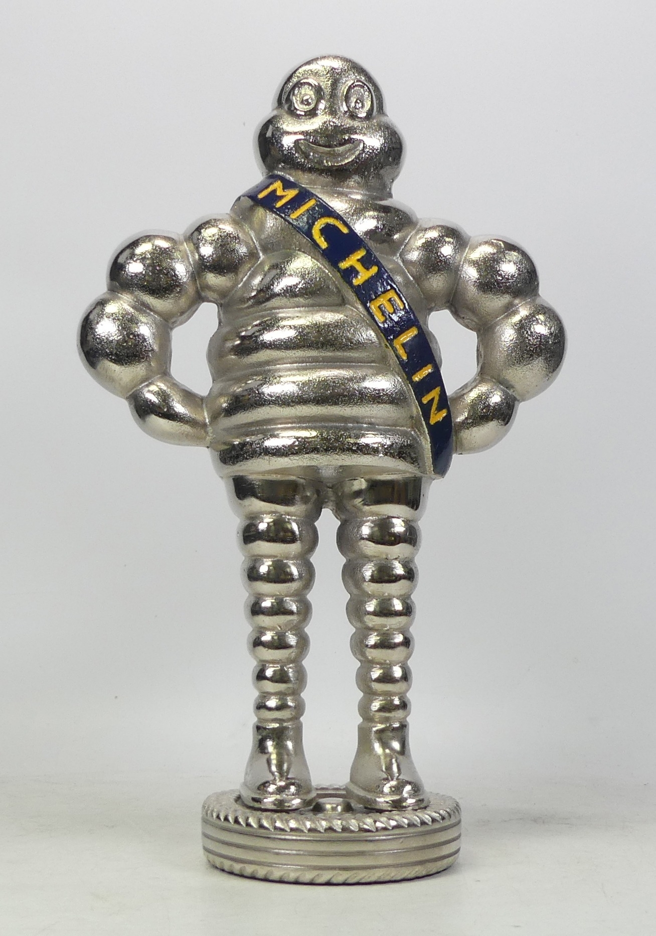Michelin, Advertising Bibendum Man in Chrome with Blue and Yellow Sash. Height: 37cm