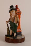 W. H. Goss, Dickensian type porcelain figure of an Urchin leaning against a painted orange post. a/