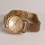 9ct hallmarked gold Omega gent's mid size wrist watch, on 9ct gold bracelet, winds, ticks, sets &