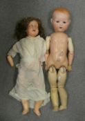 Two Armand Marseille Dolls to include bisque babies head detached from a jointed body eyes not
