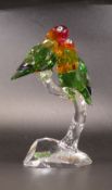 Swarovski Crystal Love Birds in green, yellow, red on a clear stand, 17cm tall, boxed with