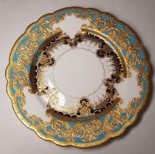 A Lynton shaped circular cabinet plate, with three shaped cartouches, within raised gilt acanthus