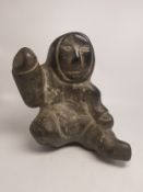 A late 20th century Canadian Inuit carved green mottled stone sculpture, 21cm high.