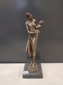 Large bronze effect sculpture of an African lady and baby, raised on a stone base, overall height