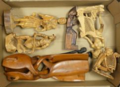 A collection of carved wooden figures together with ebony letter openers (1 tray).