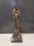 Large bronze effect sculpture of an African shepherdess, raised on a stone base, overall height