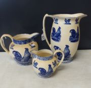 Graduated set of three Moorland Chelsea Works jugs, decorated with cocks, tallest 29cm (3).