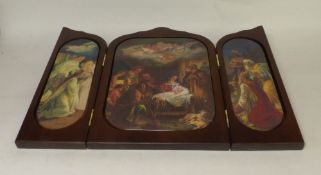 A wooden triptych depicting scenes related to the Nativity. (H: 32cm x L: 48cm)