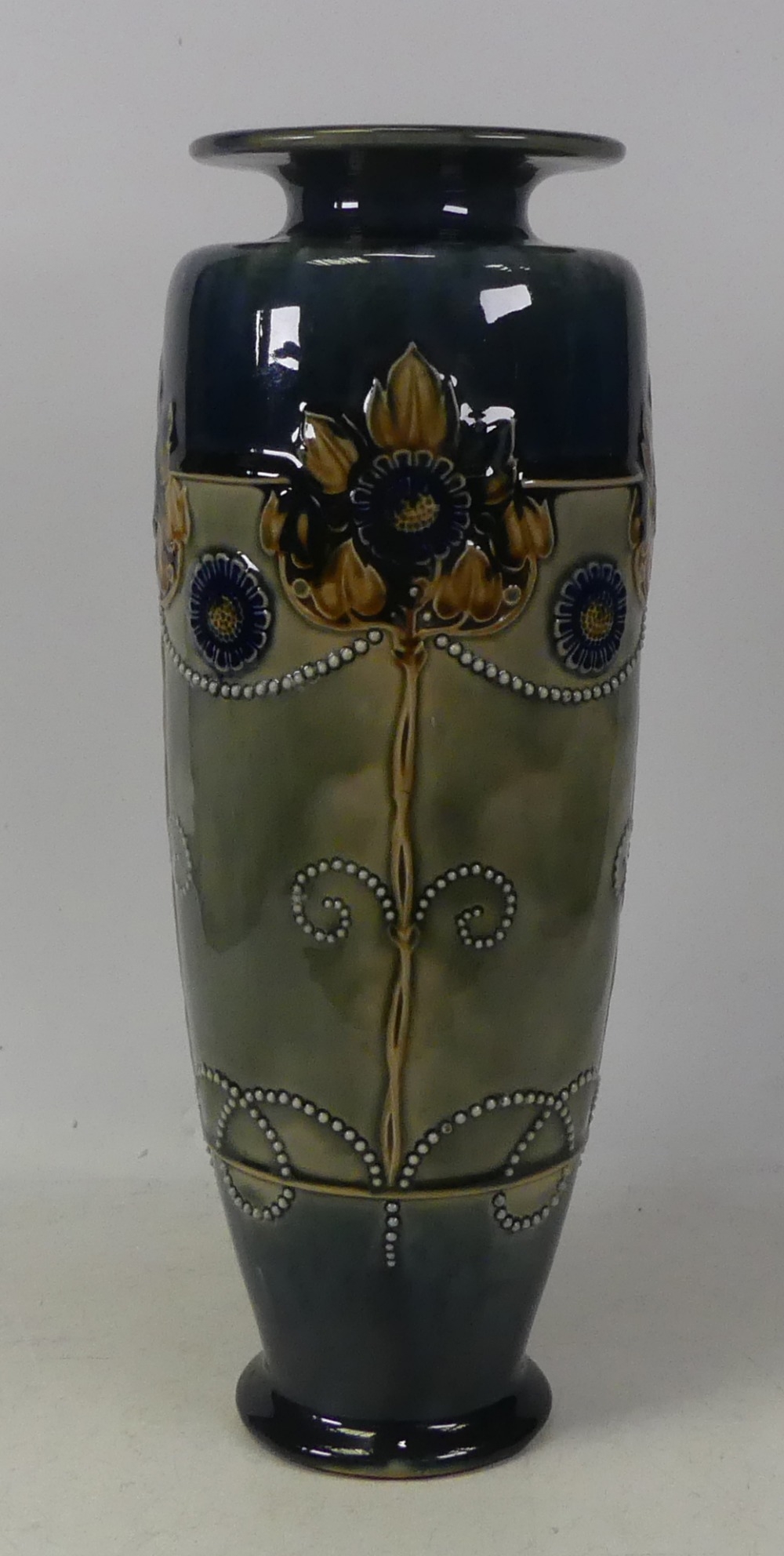 Royal Doulton Lambeth Stoneware vase decorated with art nouveau flowers. Height 35cm