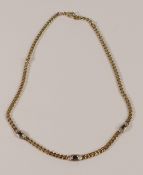 9ct gold necklace set with three oval dark blue sapphires, L.15.5inch/40cm, 6.8g.