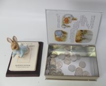 The Tale of Peter Rabbit hinged tin box depicted as a book to include twenty three 50p coins some of