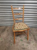 Child's waxed pine ladder-back chair with floral seat pad.