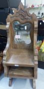 Freestanding carved wooden mirror with storage bay and shelf, height 65cm.