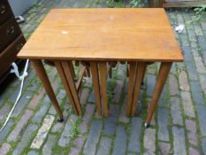 Teak side table raised on metal castor supports housing 3 metamorphic occasional tables 62cm W x