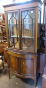 Inlaid mahogany display cabinet with storage below, raised on tapering square supports, key