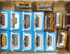 A collection of boxed OO gauge freight wagons and tankers to include Mainline 37-149 plank wagon,