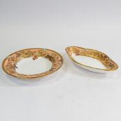 A luxuriously decorated rimmed bowl with heavy gilt floral/butterfly design on salmon pink ground