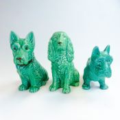 Three Sylvac green glazed dogs to include:- Seated Terrier with brown collar model No.1207, standing